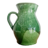 Old green pitcher in painted terracotta