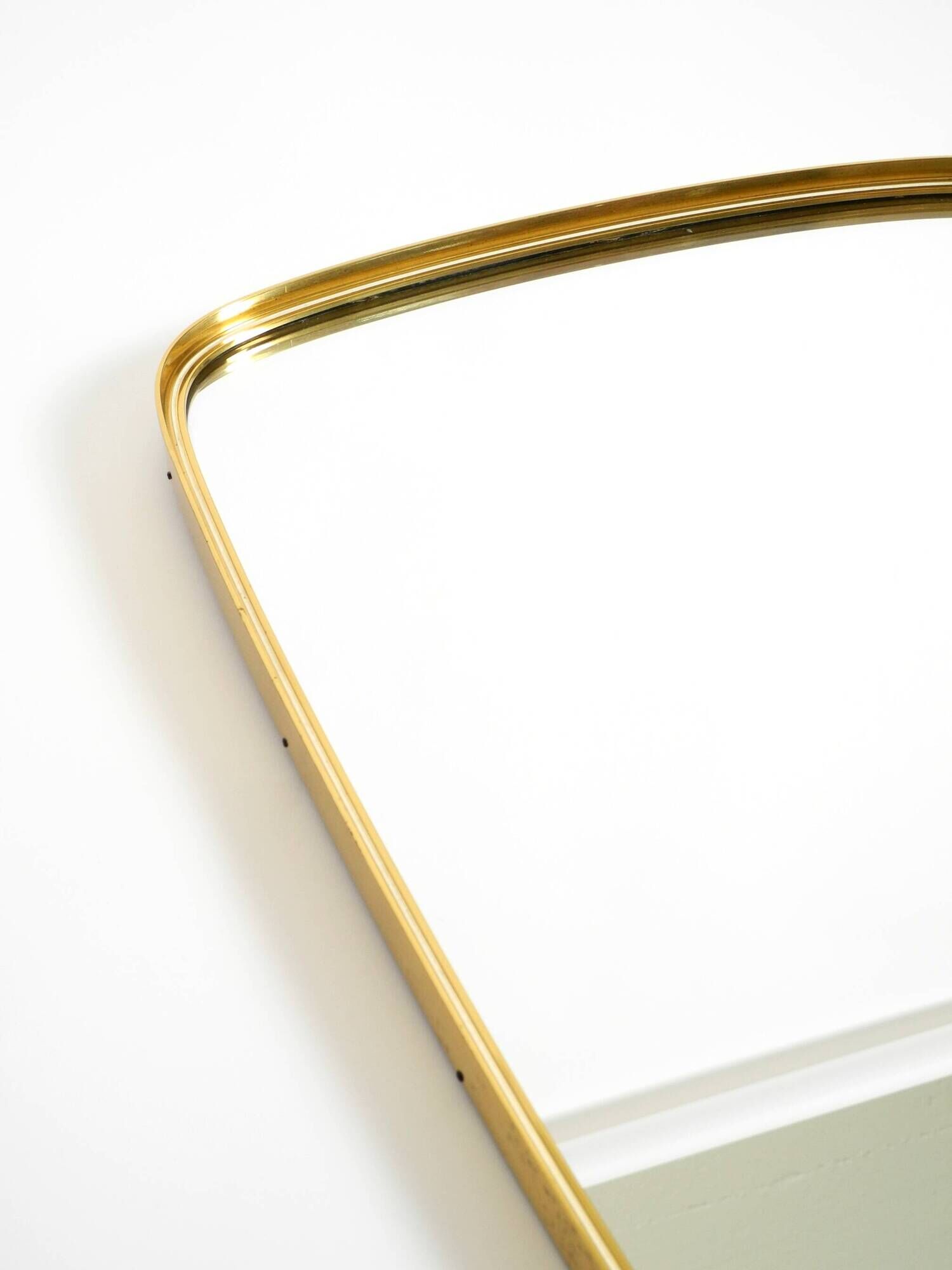 A pair of rare Mid Century "Münchener Zierspiegel" brass wall mirrors
