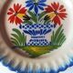 Pair of antique plates in popular earthenware with a floral basket decoration on the edge.