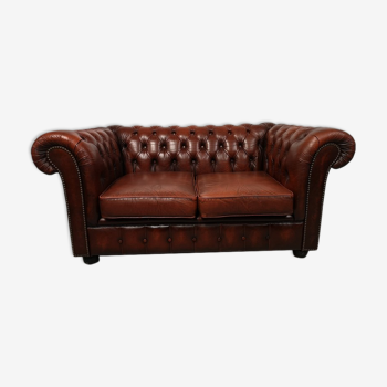 Two-seater brown leather chesterfield sofa