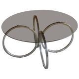 Vintage tubular coffee table in chrome with a transparent glass top, Mid-Century style 1960s.