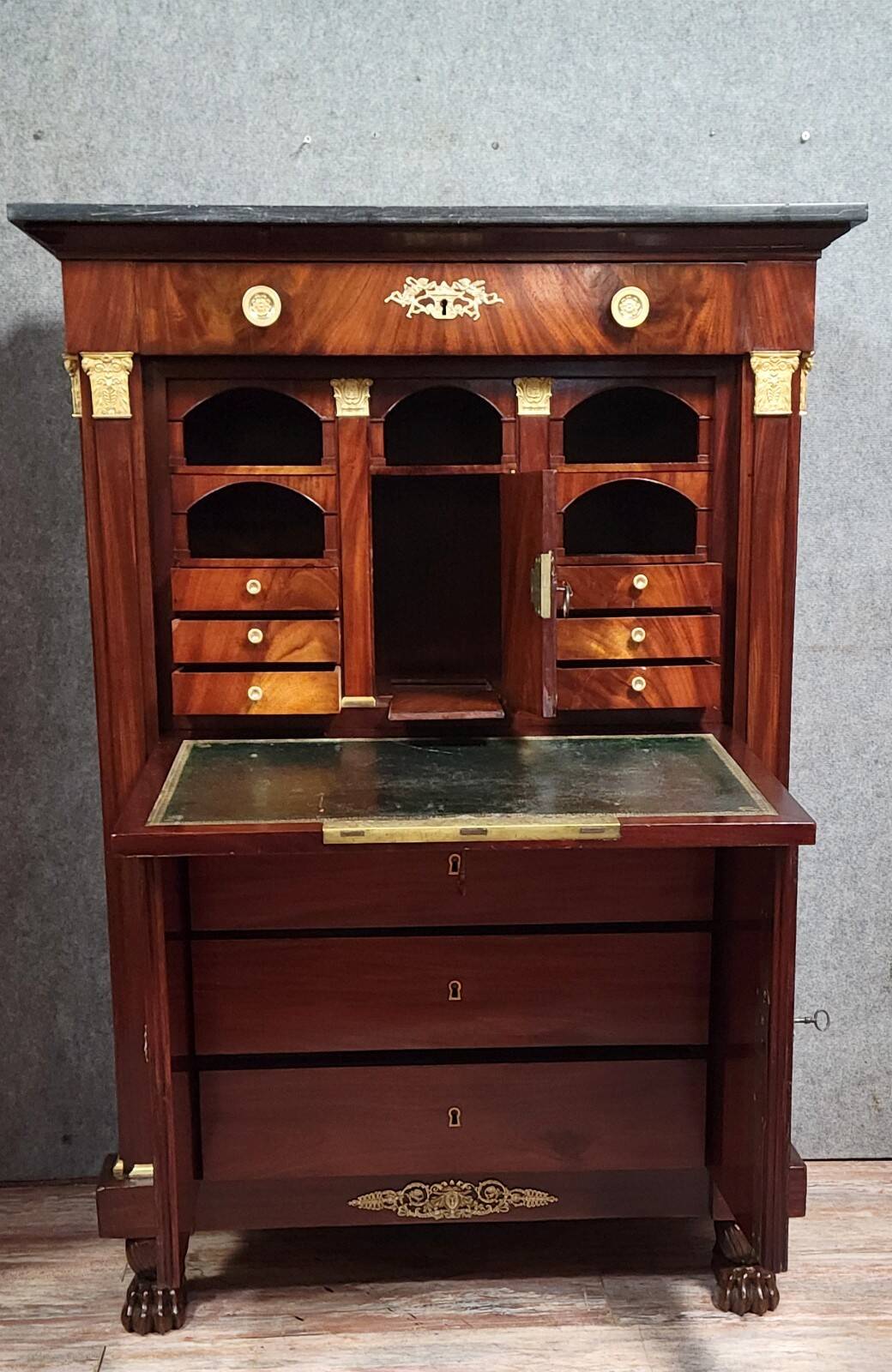 Rare four-column secretary from the Empire period in flame mahogany and bronze.