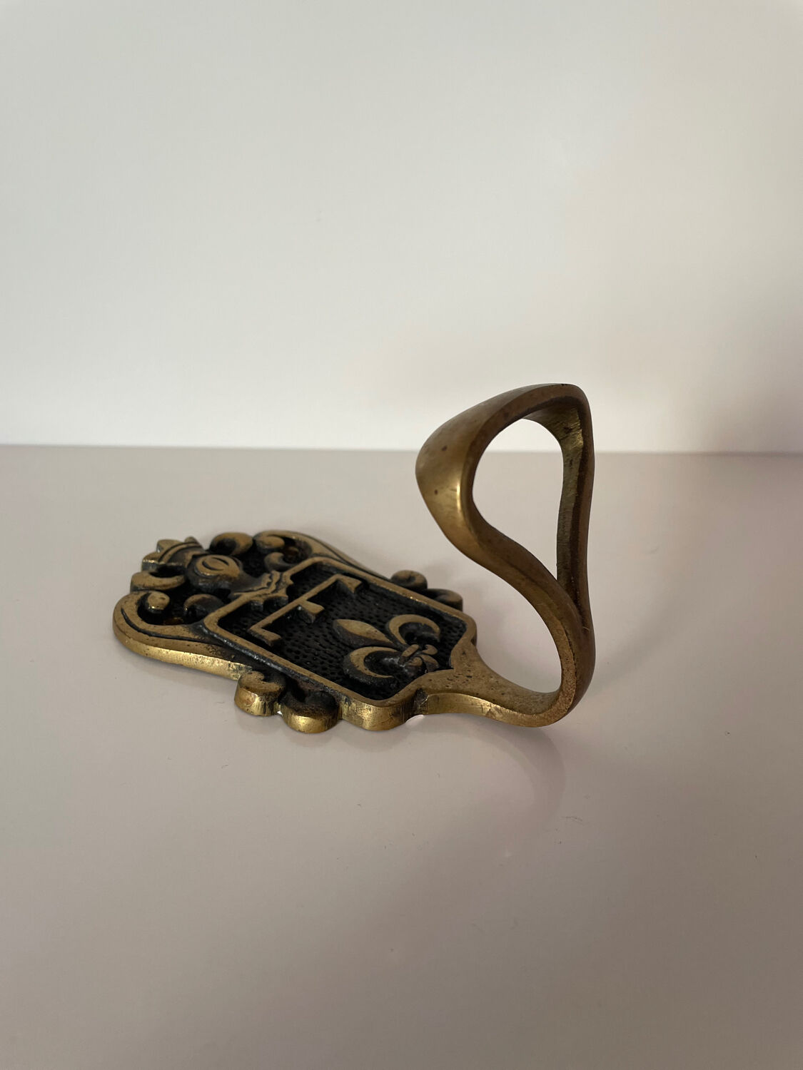 Brass hook fleur-de-lys decoration