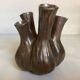Tulip vase with ceramic flowers in brown and gold.