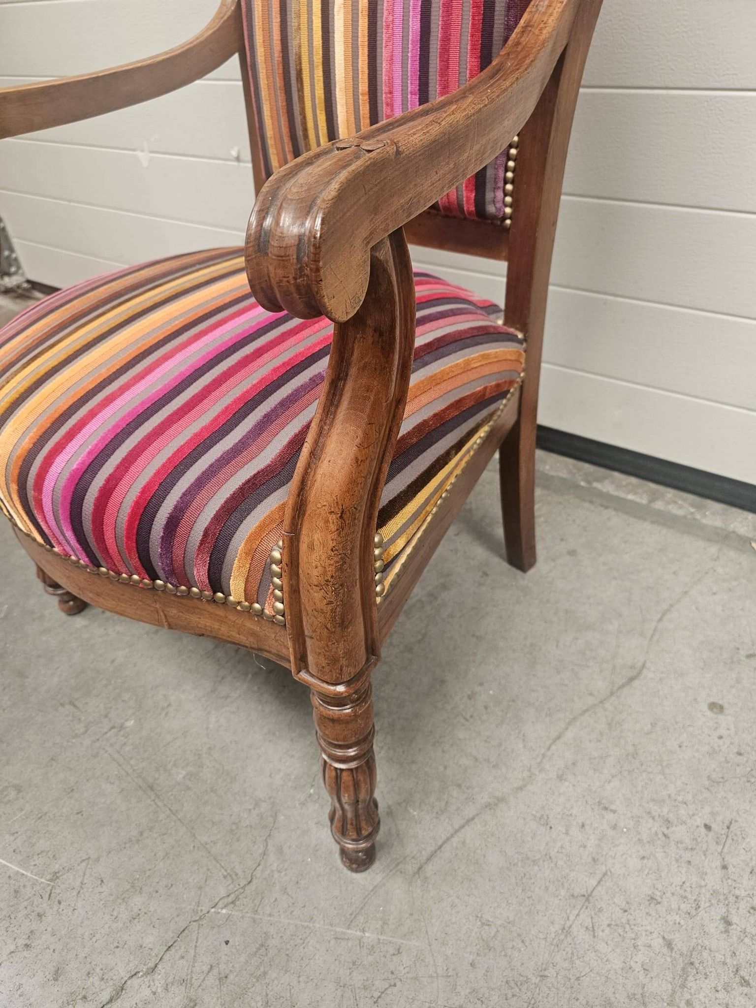 Antique striped multicoloured velvet armchair with turned legs.