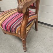 Antique striped multicoloured velvet armchair with turned legs.