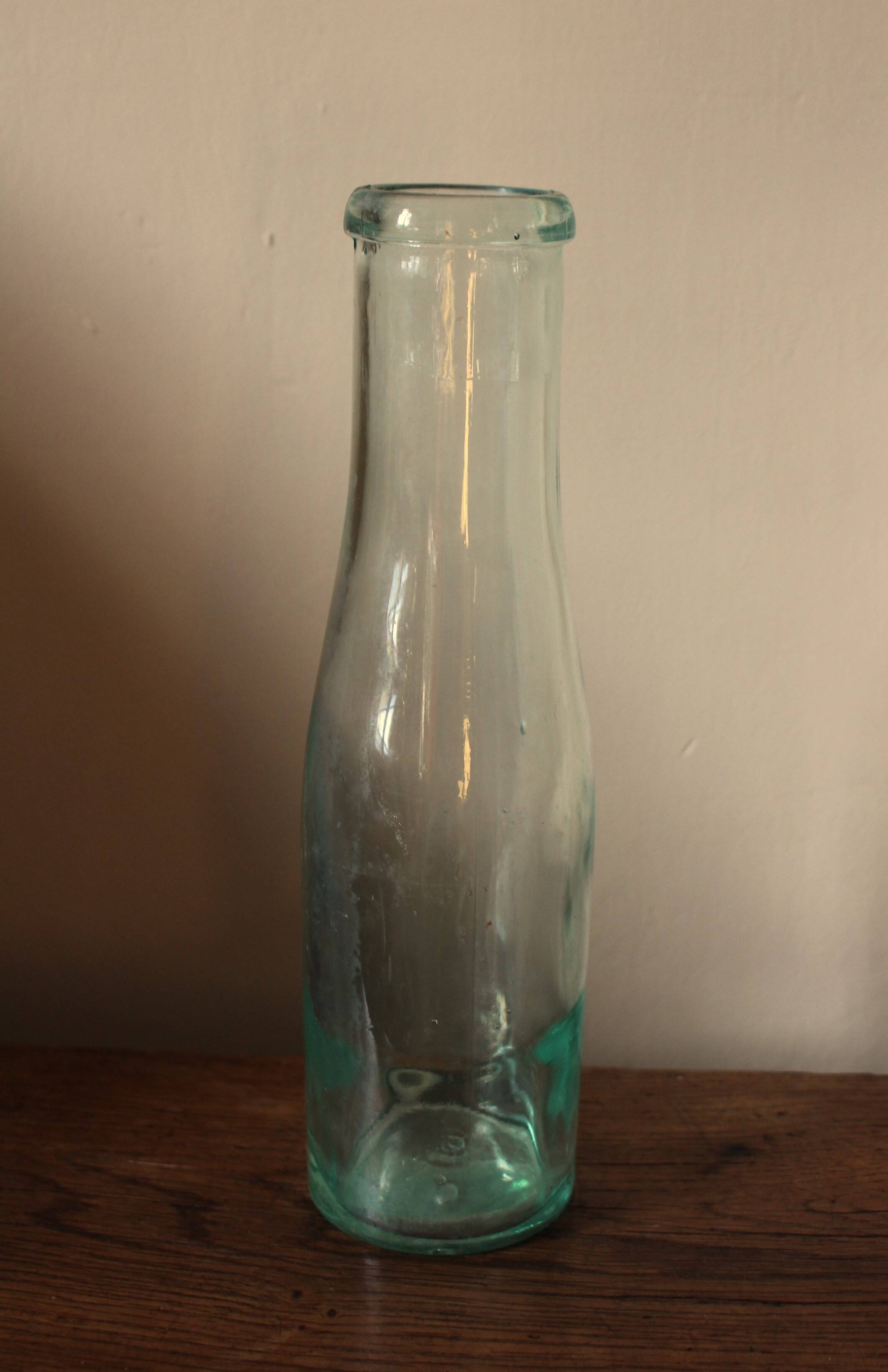 Antique glass milk bottle carafe