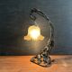 Art Nouveau wall light in wrought iron with vine decoration, early 20th century.