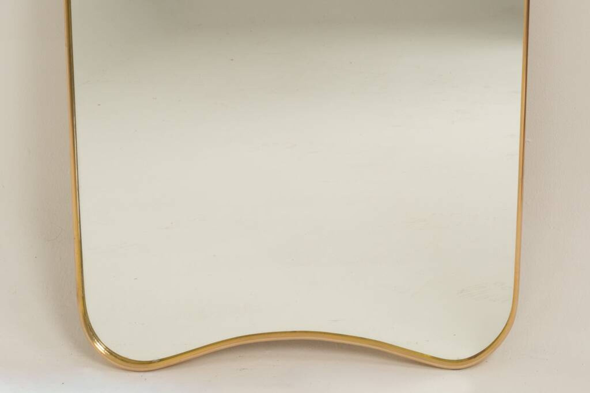 Patinated brass-framed mirror. 1980s/90s.