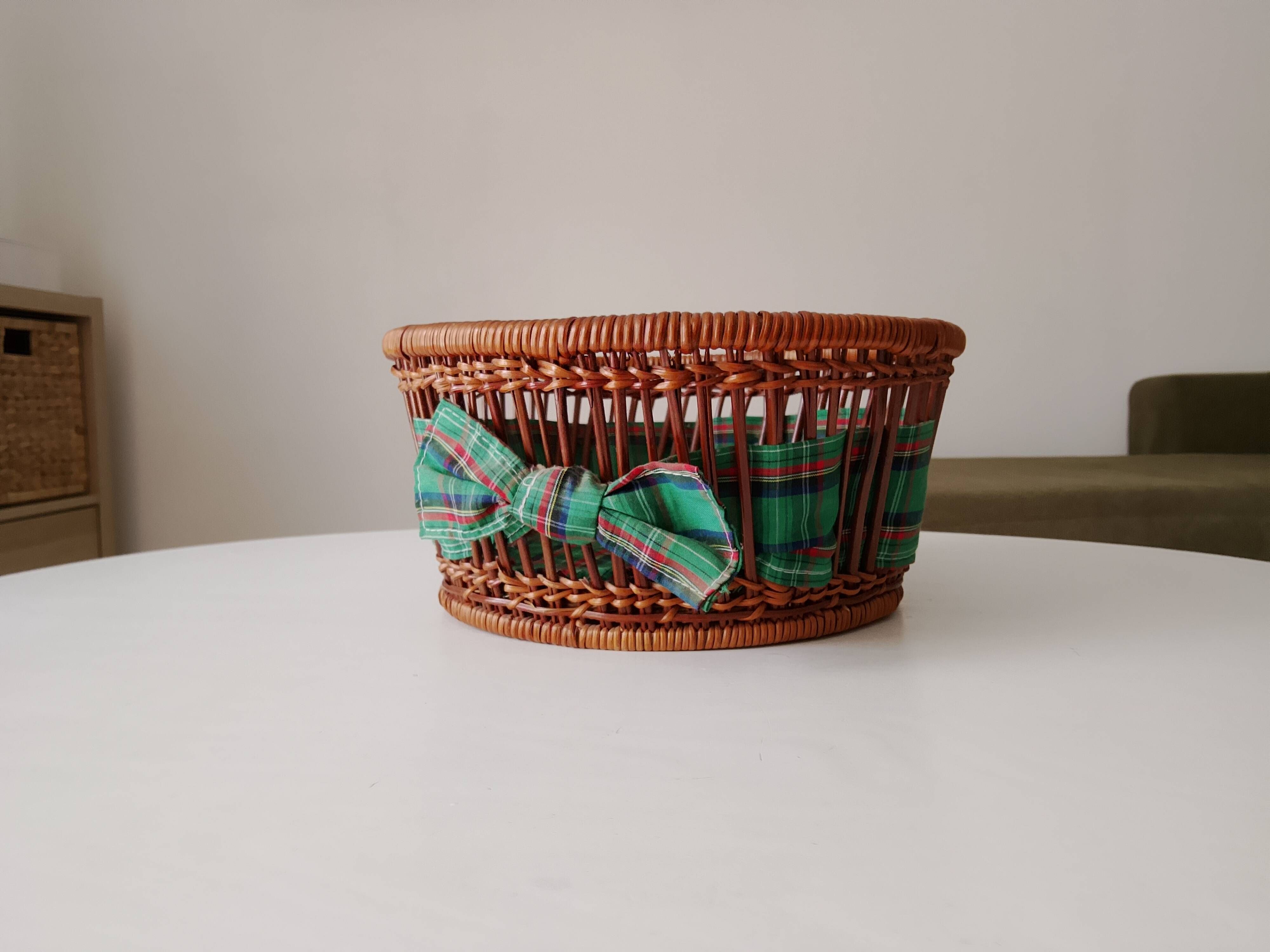 Vintage wicker and rattan basket with tartan fabric.