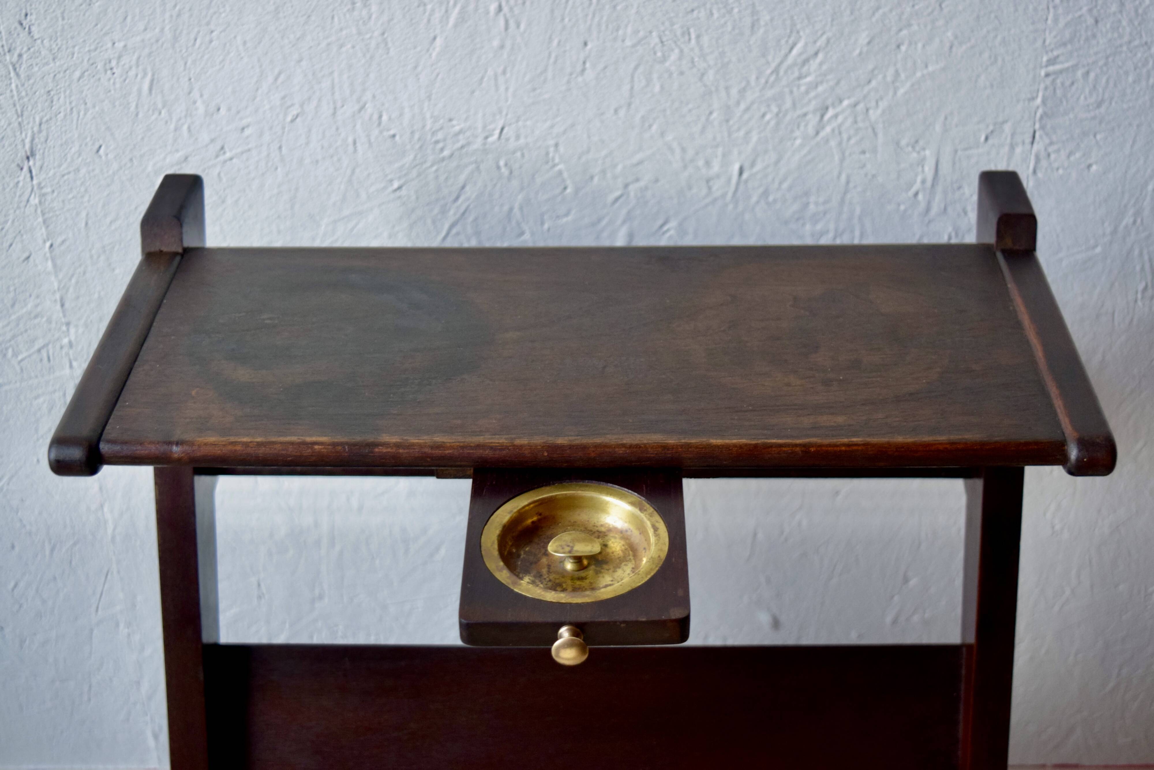 Old Scandinavian style magazine rack in dark wood with integrated brass ashtray