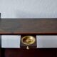 Old Scandinavian style magazine rack in dark wood with integrated brass ashtray