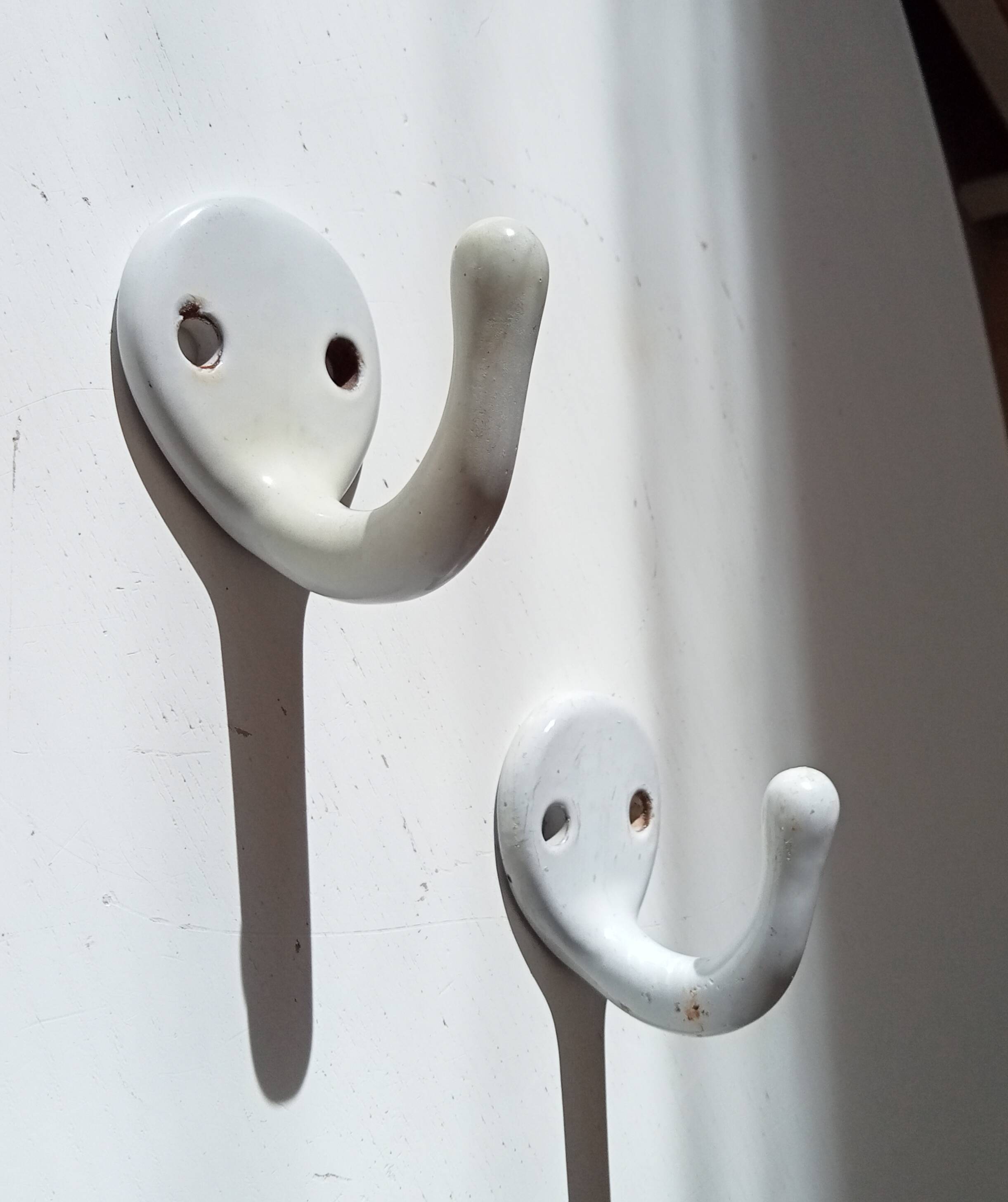 Antique enamelled cast iron wall hook from the 30s/40s