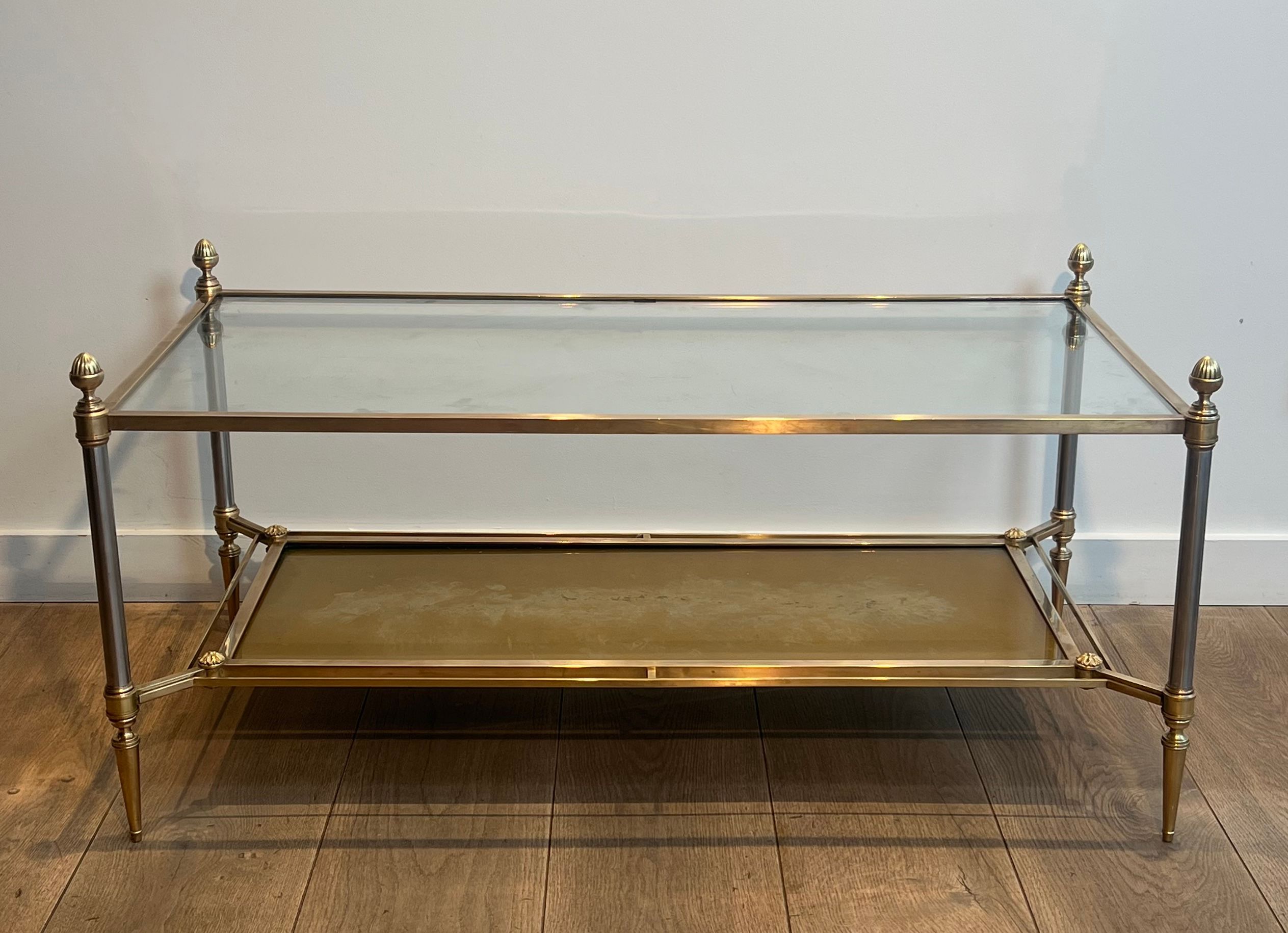 Coffee table in brass, brushed steel, glass, and gilded eglomisé mirror from Maison Jansen.