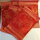 Set of 6 small table napkins in red brocade.