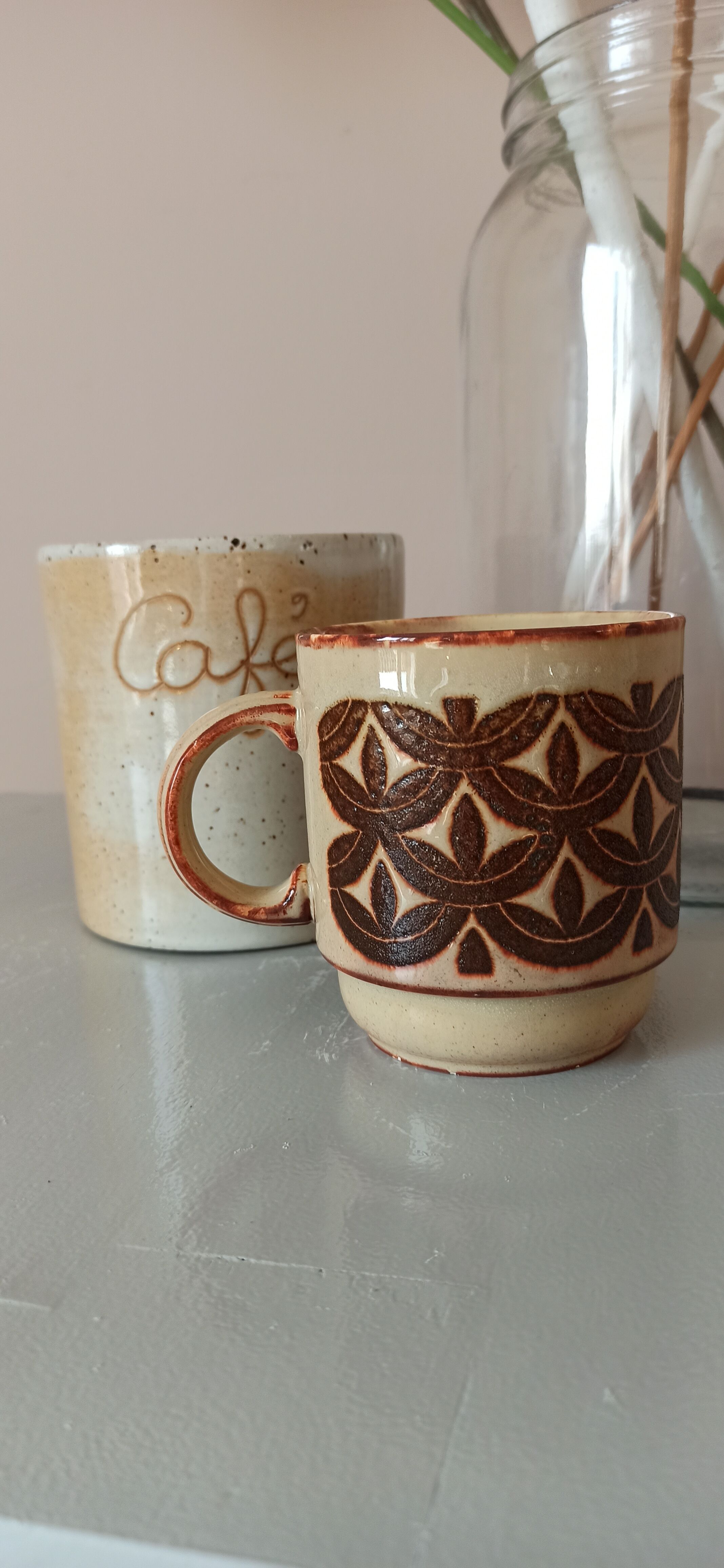 Coffee pot and mug cup in sandstone