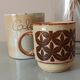 Coffee pot and mug cup in sandstone