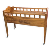 Baby cot made of solid walnut on wheels