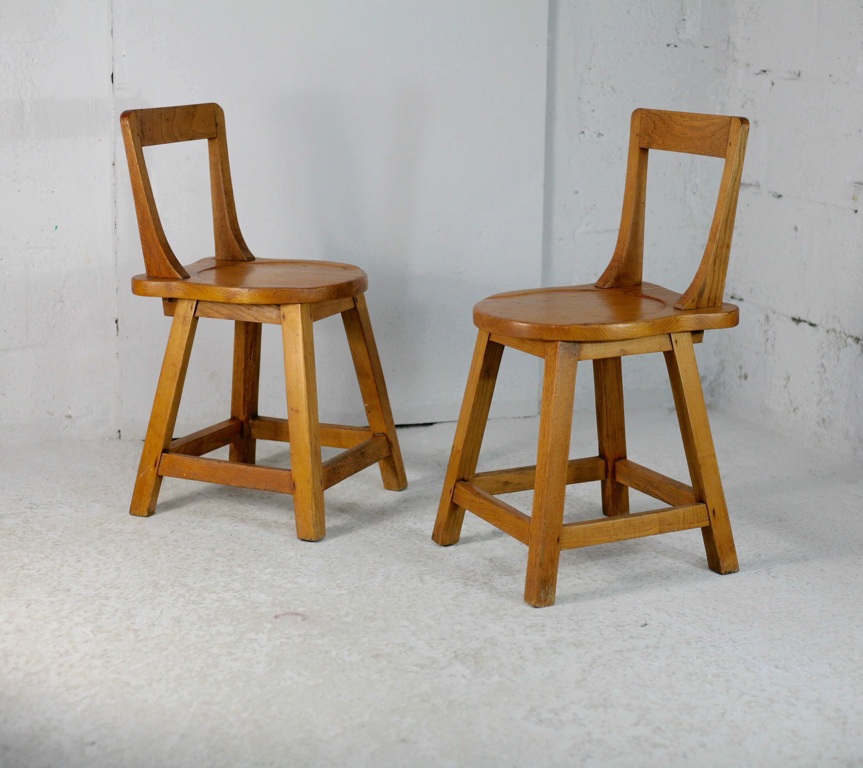 Pair of brutalist wooden back stools. France, circa 1960