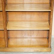 Pair of Sheraton Revival bookcases in satinwood, walnut, and yew.