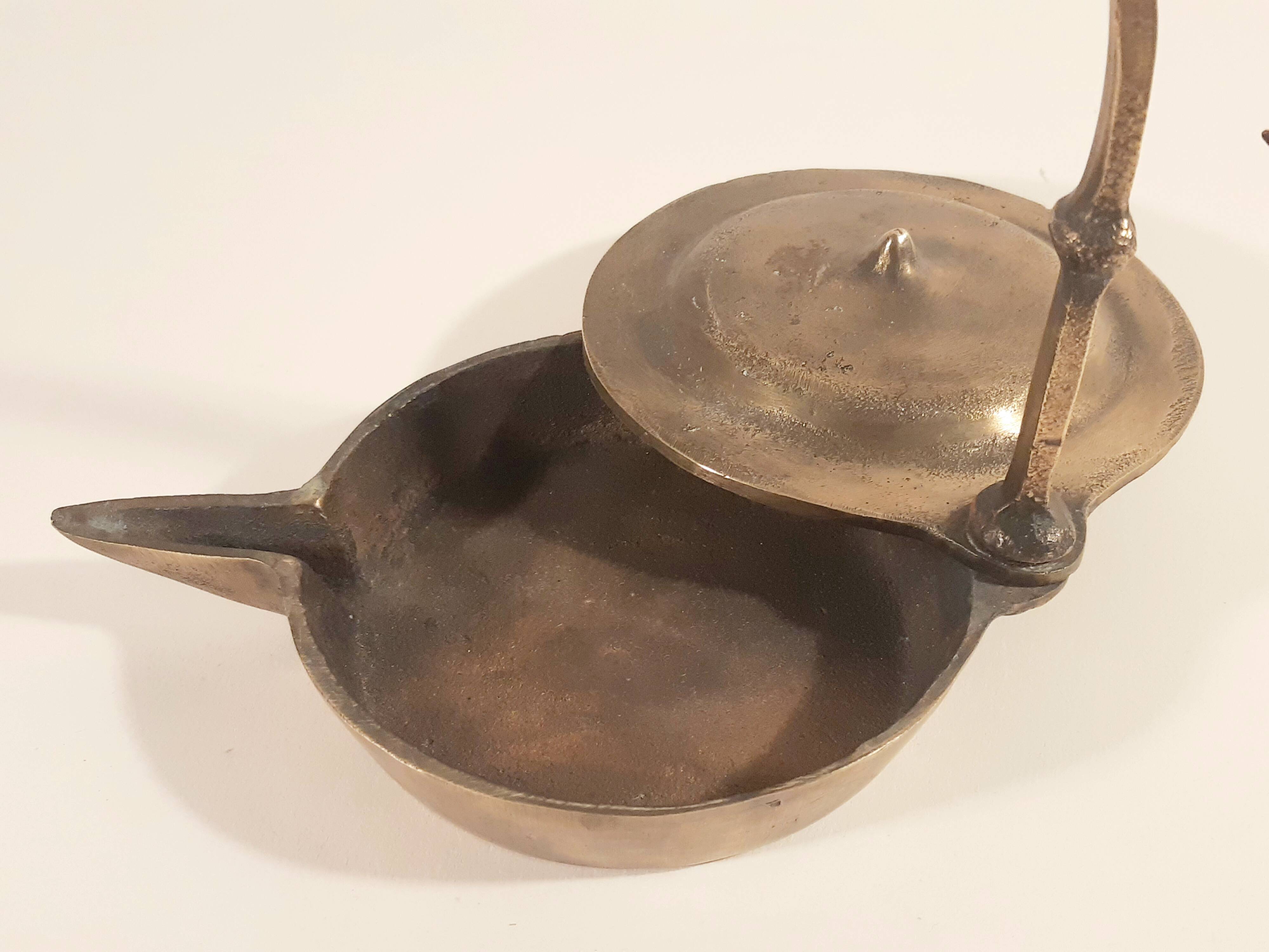 Old oil lamp in golden brass to hang
