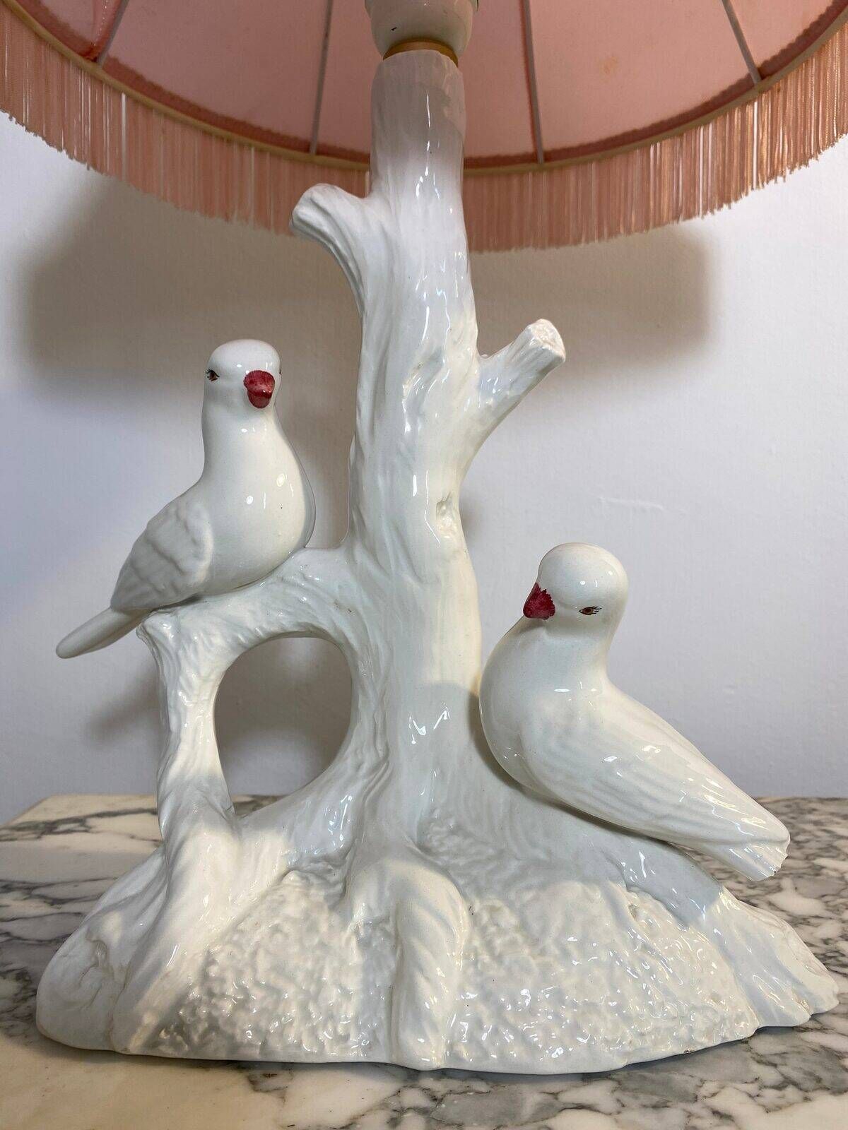 Ceramic lamp with birds, pink fringed shade, 1950s.
