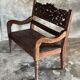 Small antique Indonesian bench in carved teak with plant and floral motifs.