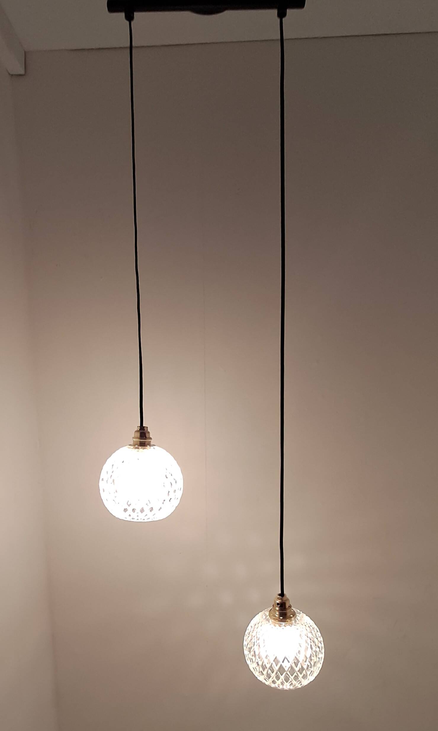 Two-light pendant in a cascade of cut crystal globe