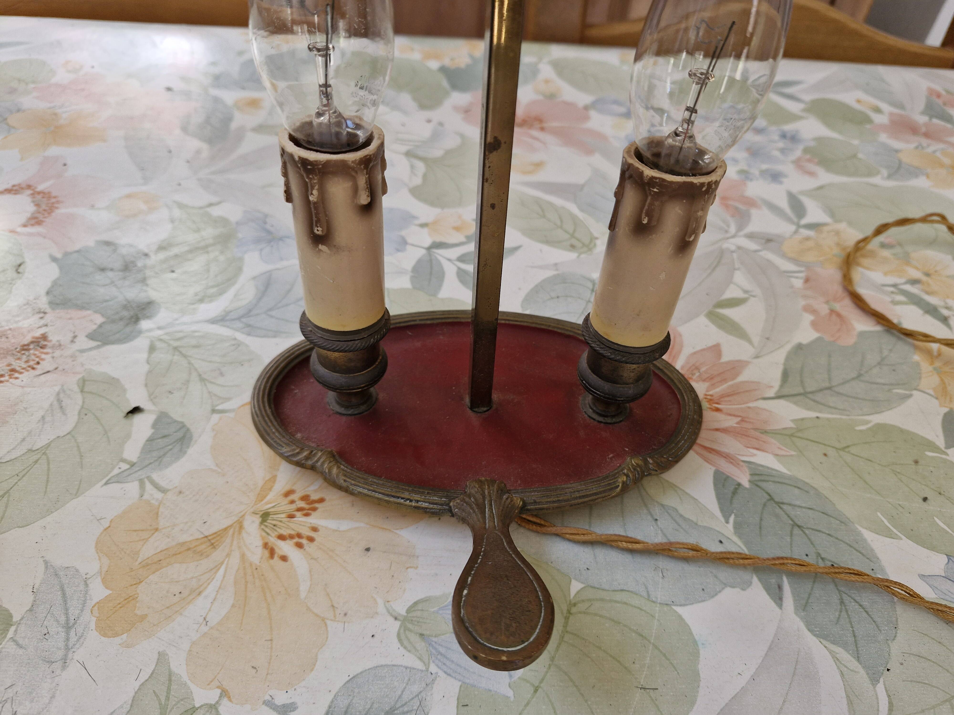 Old silver-plated bronze lamp, except for the arms which are not silver.