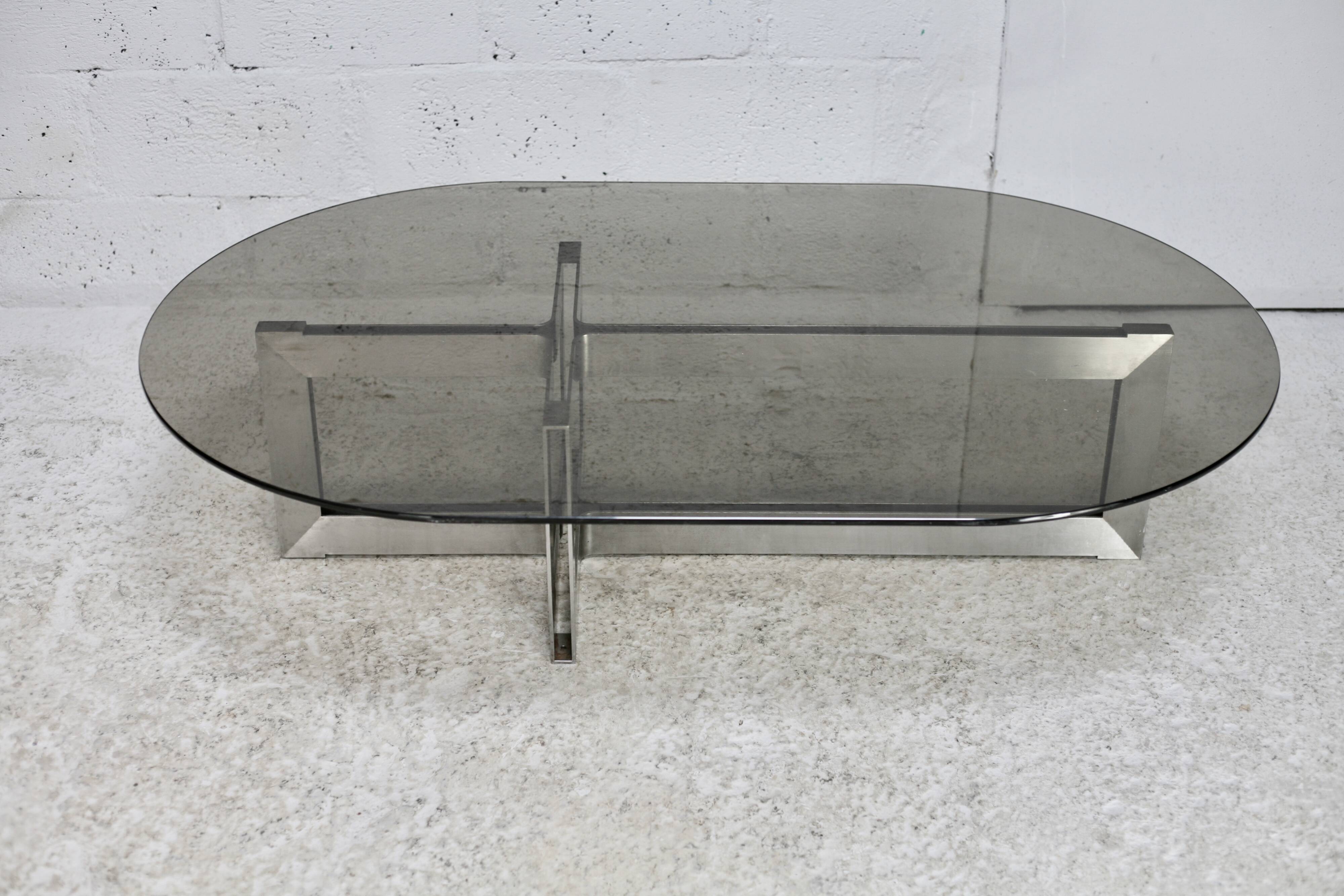 Coffee table with steel base and smoked glass slab. Circa 197