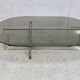 Coffee table with steel base and smoked glass slab. Circa 197