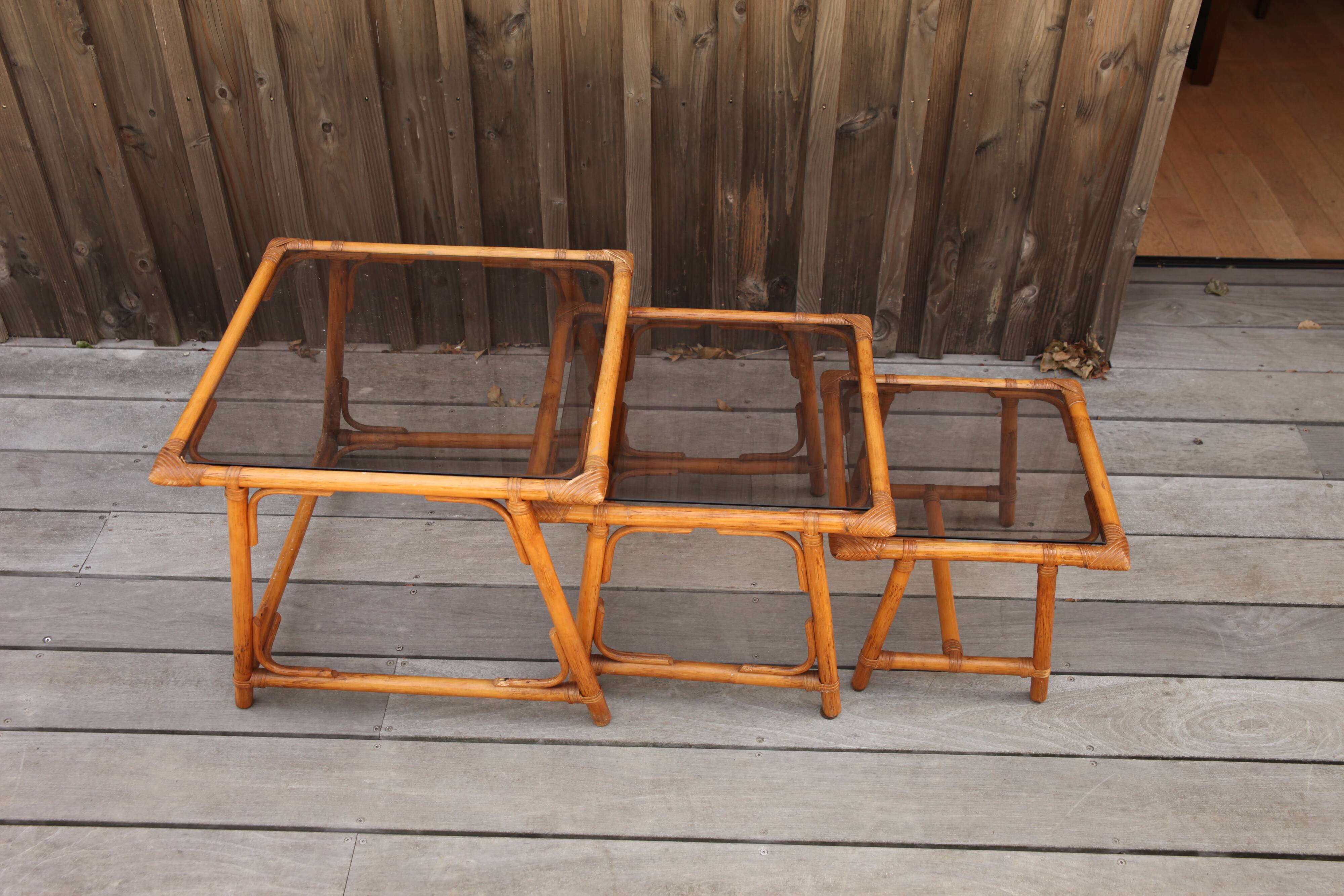 Nesting tables in rattan and glass