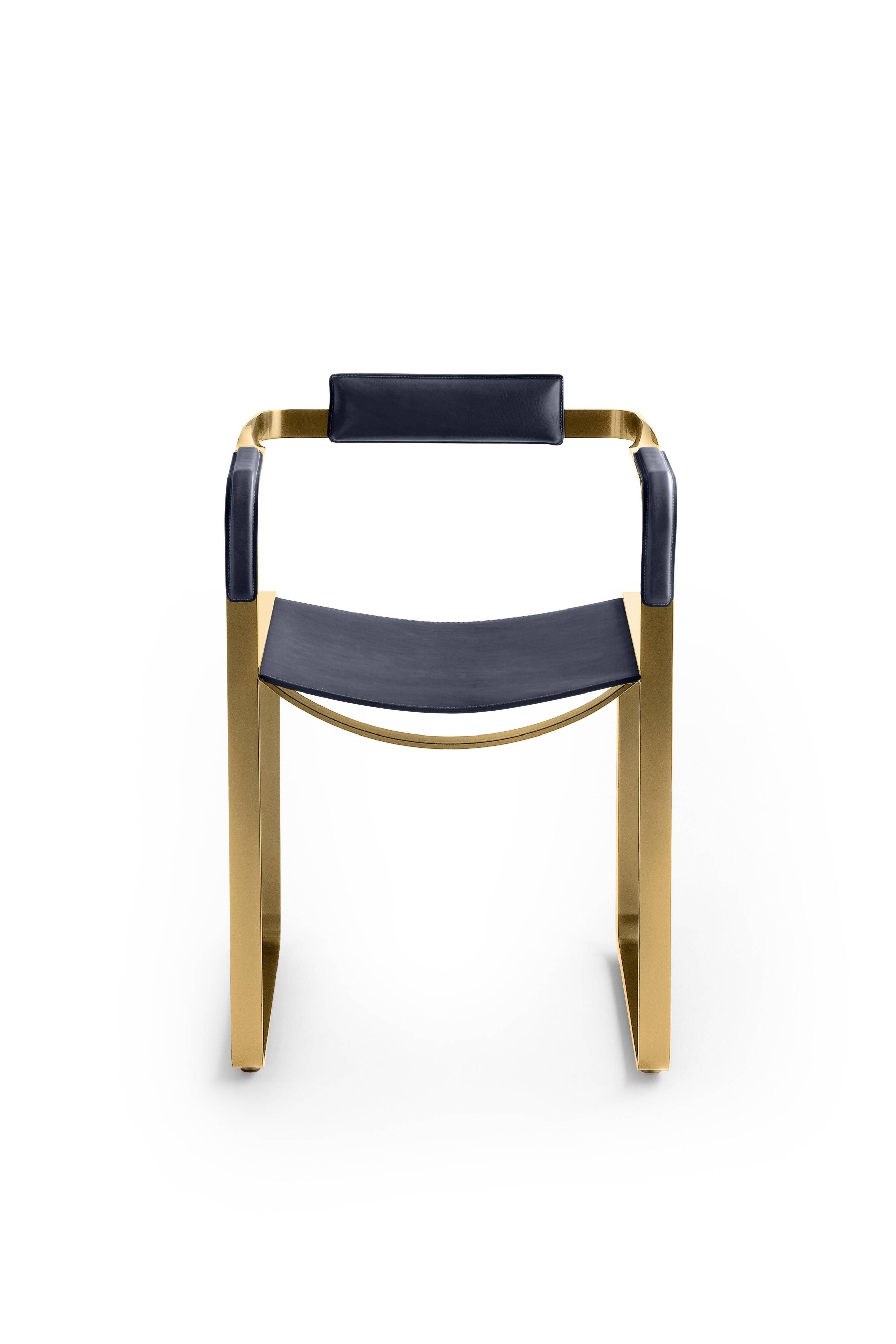Armchair, aged brass and navy blue leather, contemporary style.