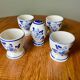 Set of 4 vintage egg cups and salt shaker in blue Delft pottery.