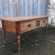 Solid cherry game table with 2 front drawers and panelled crosspieces.