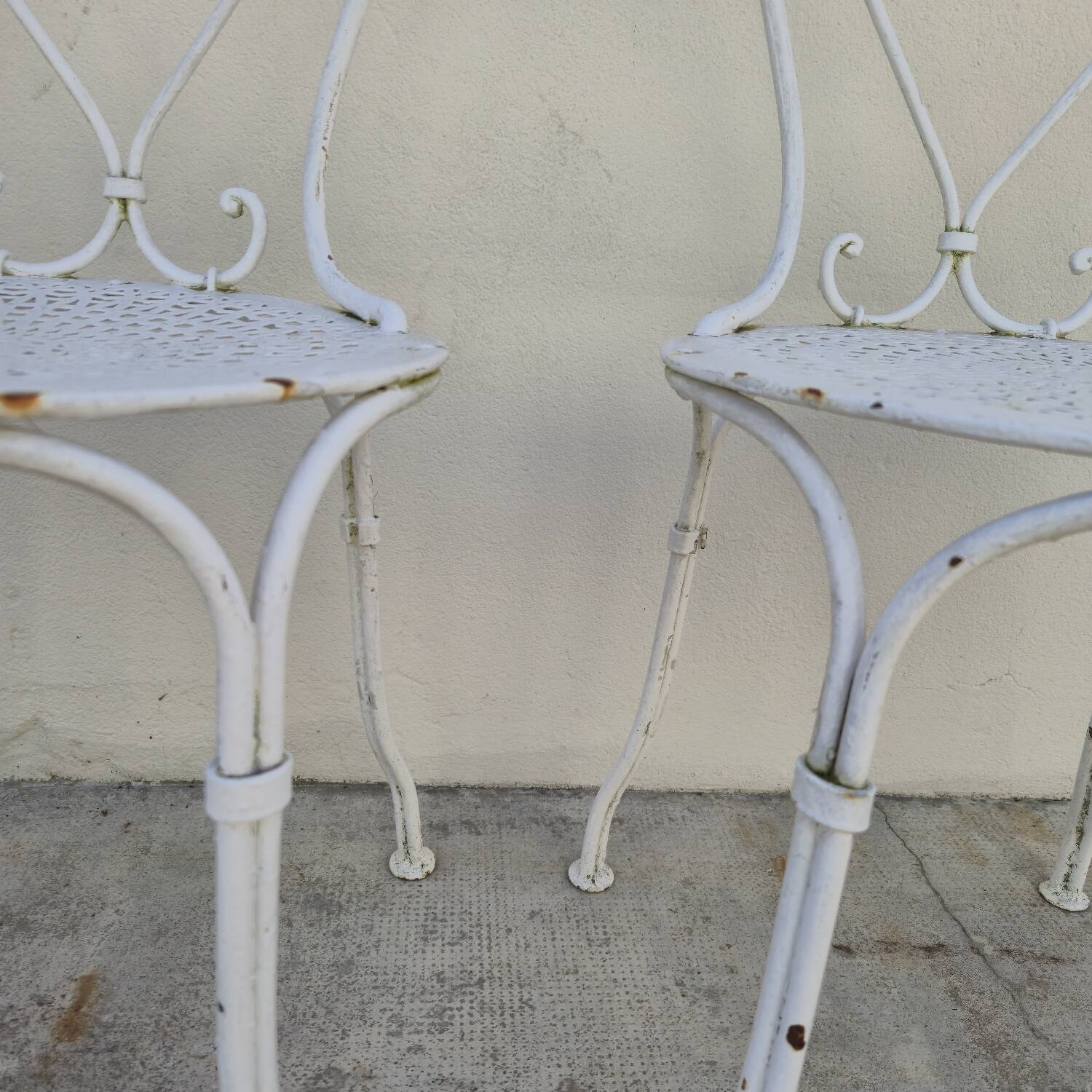 Pair of wrought iron garden chairs, antique manufacture
