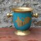 Vintage turquoise brass champagne bucket with grape decoration.