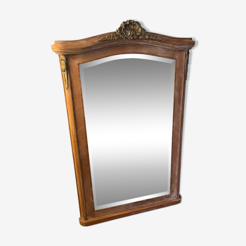 Large antique mirror in patinated wood and beveled glass gilding