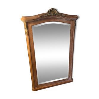 Large antique mirror in patinated wood and beveled glass gilding