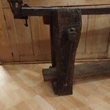 Small, very old, brutalist workbench equipped with a period workshop lamp