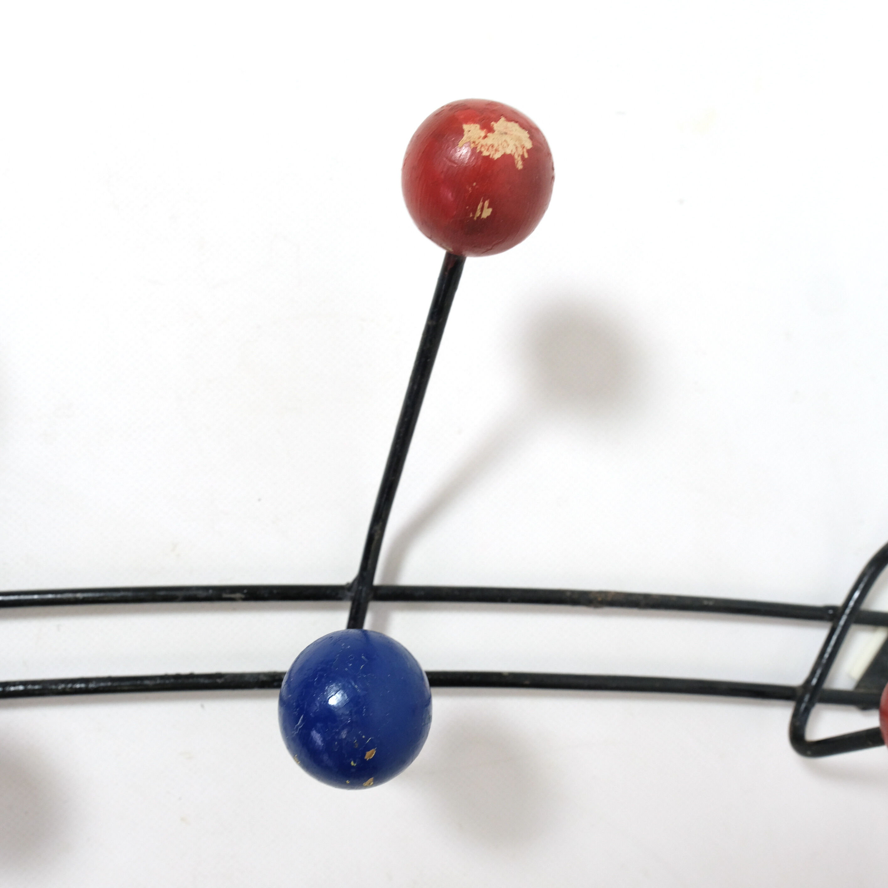 Multicolored wooden and metal coat holder