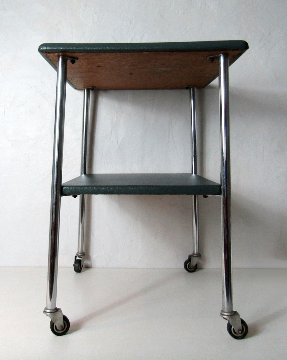 Table serves console with chrome wheels and imitation vintage khaki