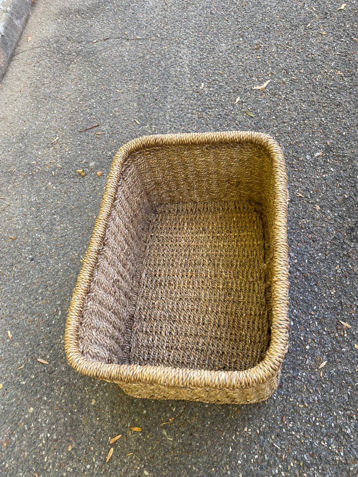 Large basket / rectangular storage bin made of woven natural fibre.