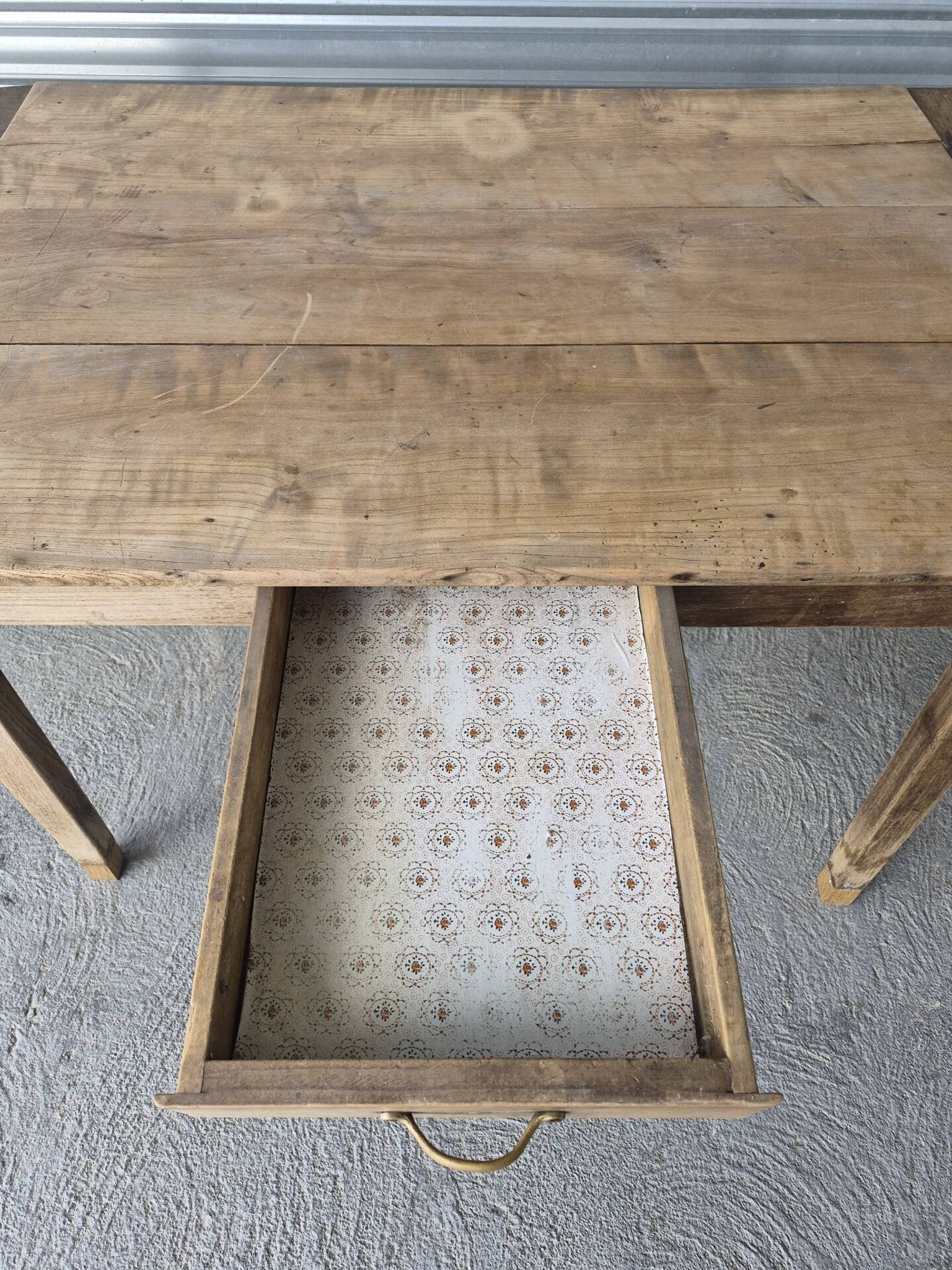 Old farmhouse table with its 2 extensions and raised legs.