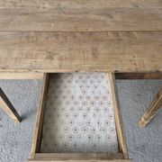 Old farmhouse table with its 2 extensions and raised legs.