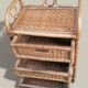 Small storage unit / freestanding shelf in light rattan.