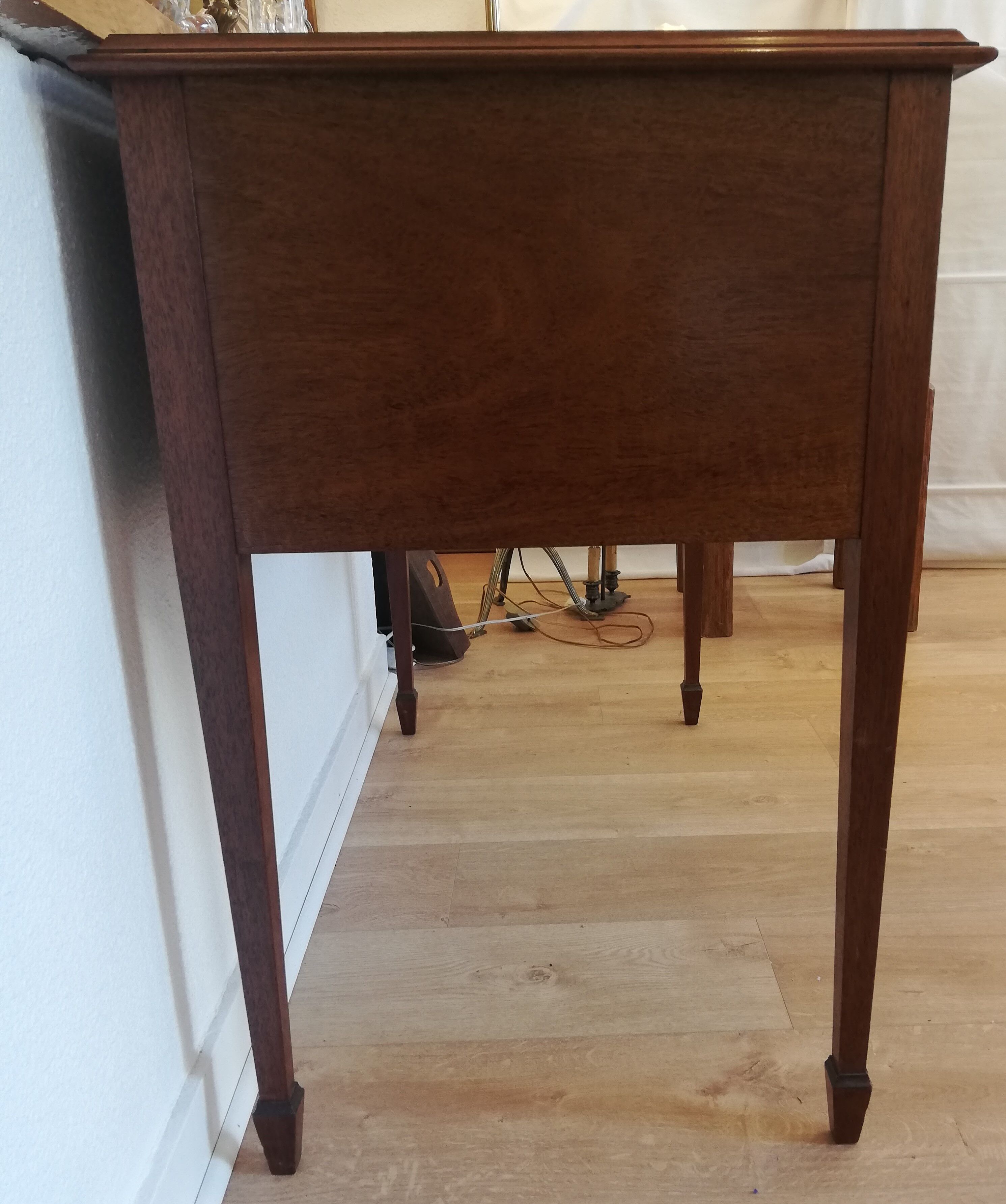 English wooden desk on top of leather