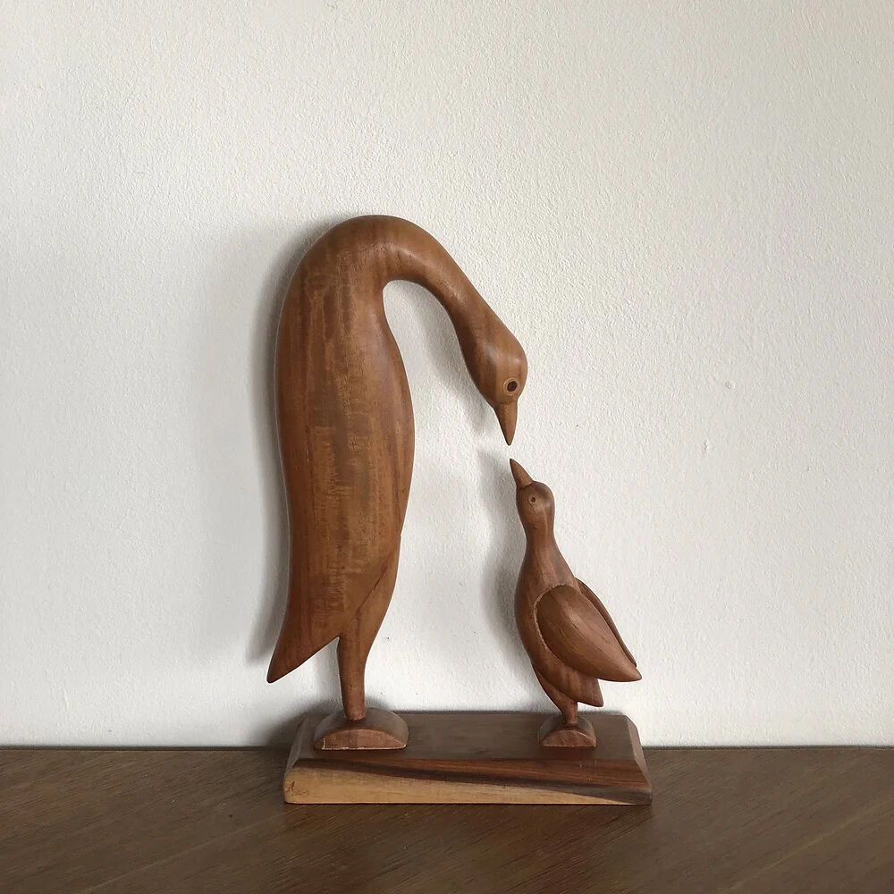 Sculpture of a goose feeding its young