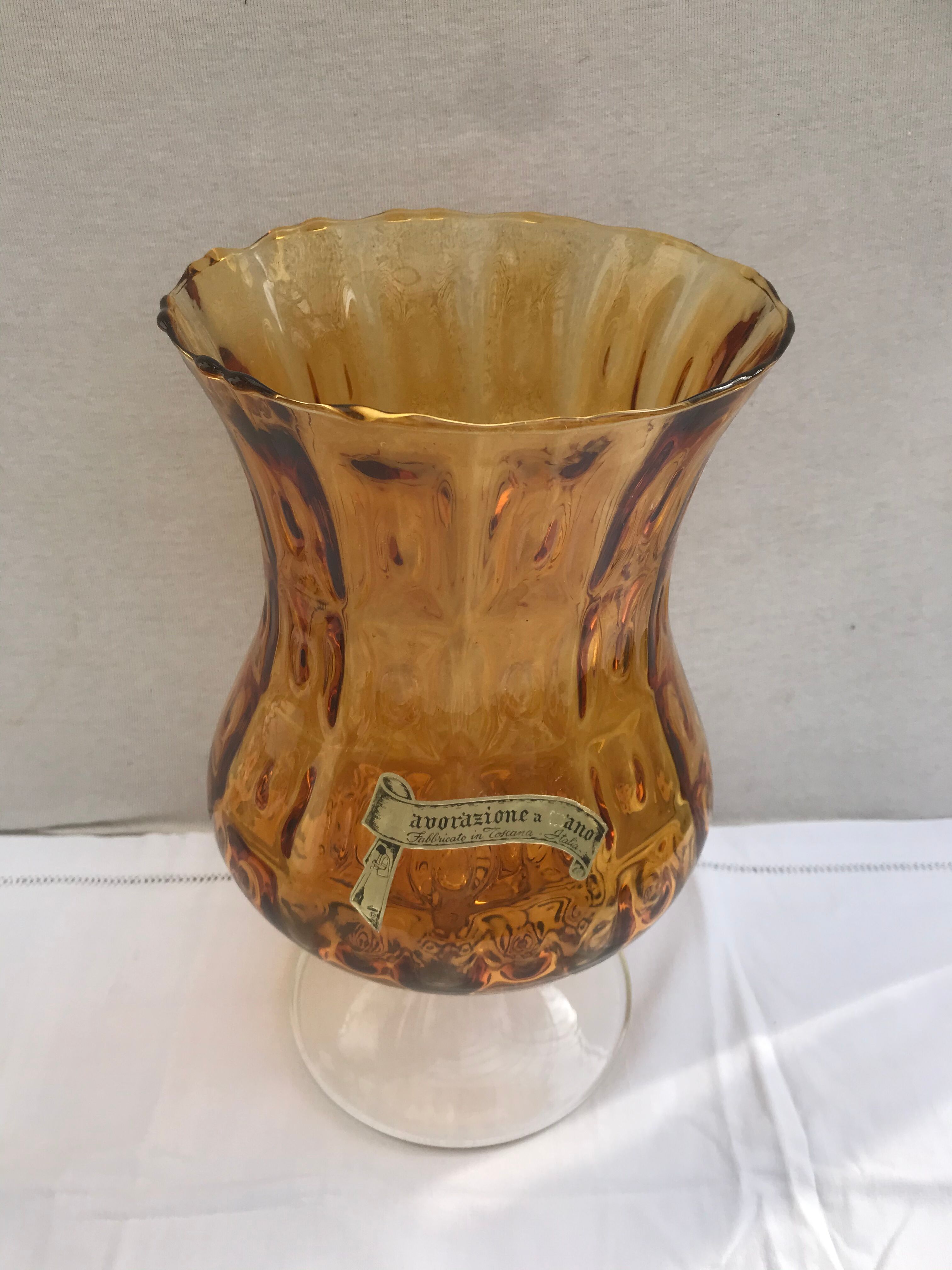 Ancient vase on foot orange glass