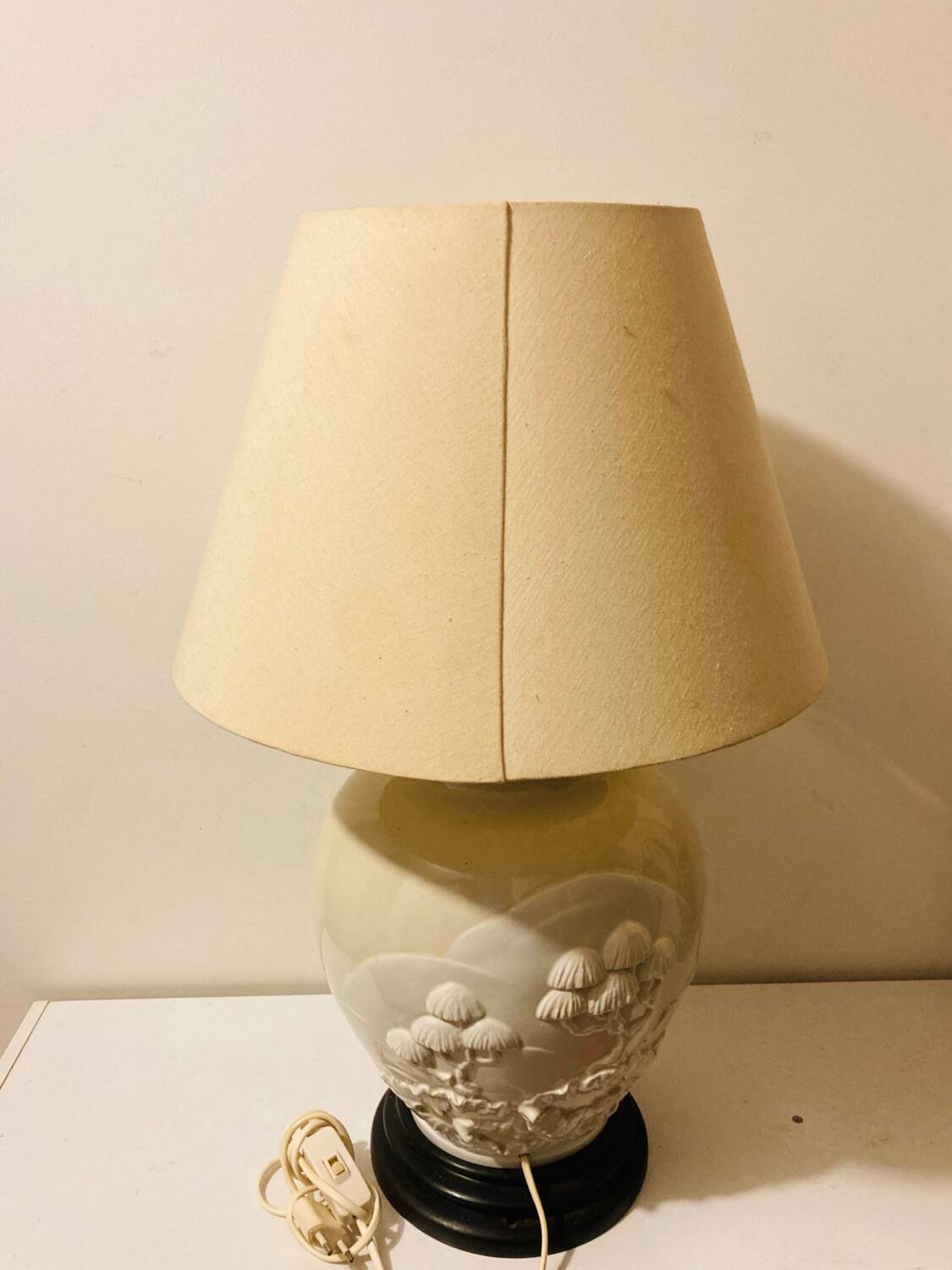 1980s ceramic table lamp with a wooden base and adjustable shade.